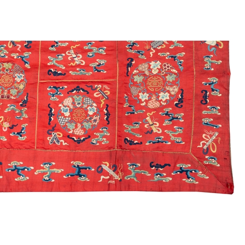 819 - A Chinese red-ground embroidered silk 'bajixiang' panel, Tie Shan Si mark, 19th C.Dim.: 253 x 122 cm... 