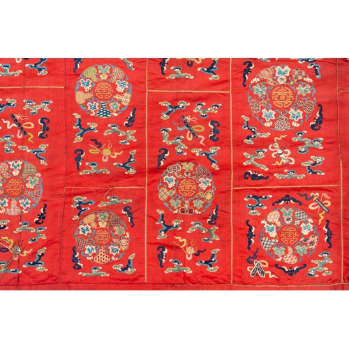 819 - A Chinese red-ground embroidered silk 'bajixiang' panel, Tie Shan Si mark, 19th C.Dim.: 253 x 122 cm... 