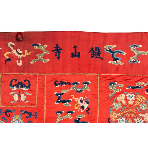 819 - A Chinese red-ground embroidered silk 'bajixiang' panel, Tie Shan Si mark, 19th C.Dim.: 253 x 122 cm... 