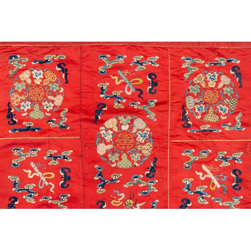 819 - A Chinese red-ground embroidered silk 'bajixiang' panel, Tie Shan Si mark, 19th C.Dim.: 253 x 122 cm... 