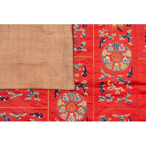 819 - A Chinese red-ground embroidered silk 'bajixiang' panel, Tie Shan Si mark, 19th C.Dim.: 253 x 122 cm... 