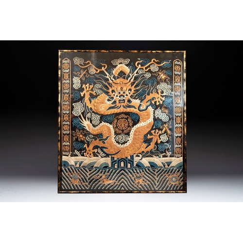 821 - A Chinese embroidered silk tapestry with a five-clawed dragon among clouds and bajixiang, 18/19th C.... 