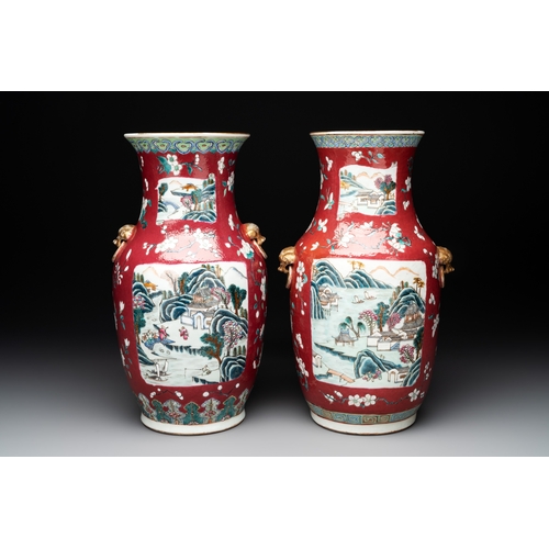 88 - Two Chinese famille rose ruby-ground 'landscape' vases, 19th C.H.: 36 cm