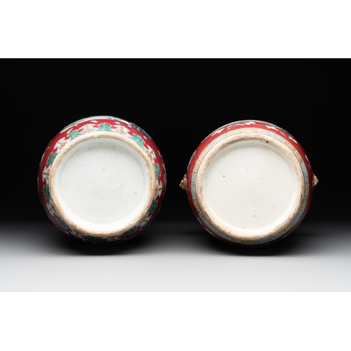 88 - Two Chinese famille rose ruby-ground 'landscape' vases, 19th C.H.: 36 cm