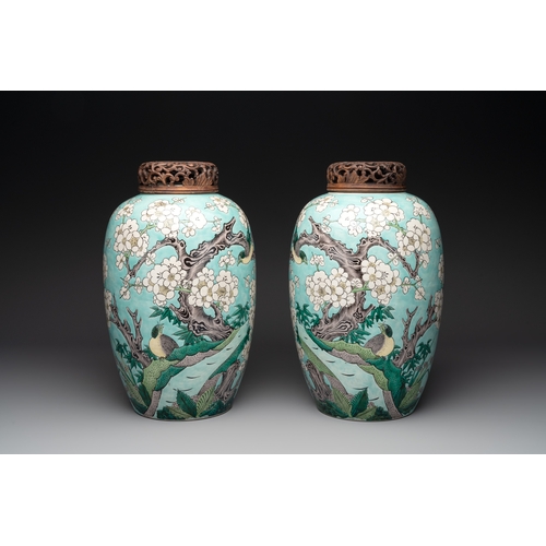 89 - A pair of fine Chinese famille verte turquoise-ground 'magpie and prunus' jars with reticulated wood... 