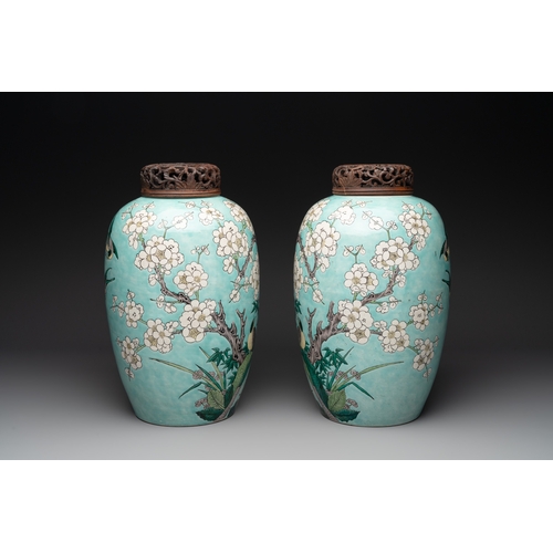 89 - A pair of fine Chinese famille verte turquoise-ground 'magpie and prunus' jars with reticulated wood... 