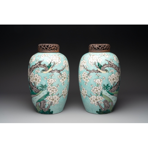 89 - A pair of fine Chinese famille verte turquoise-ground 'magpie and prunus' jars with reticulated wood... 