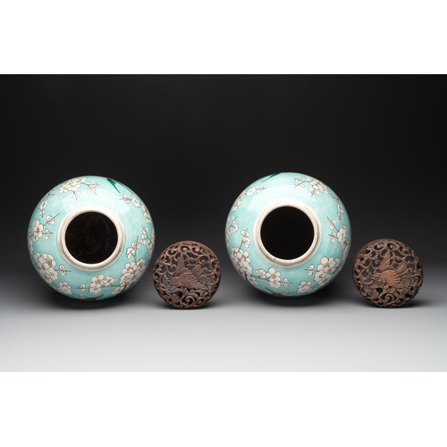 89 - A pair of fine Chinese famille verte turquoise-ground 'magpie and prunus' jars with reticulated wood... 