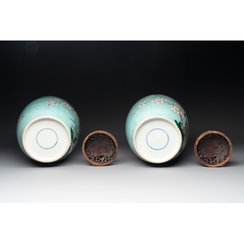 89 - A pair of fine Chinese famille verte turquoise-ground 'magpie and prunus' jars with reticulated wood... 