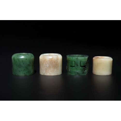 125 - Four Chinese white and spinach-green jade archer rings and a bronze box with a crane design, 19th C.... 