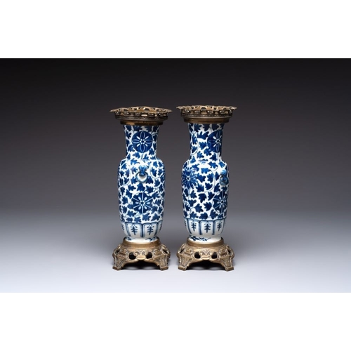 14 - A pair of Chinese blue and white bronze-mounted vases and a covered jar, 19th C.H.: 34,5 cm (the jar... 