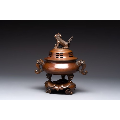 143 - A Chinese bronze tripod censer with cover and stand, a small tripod censer and a silver-inlaid iron ... 