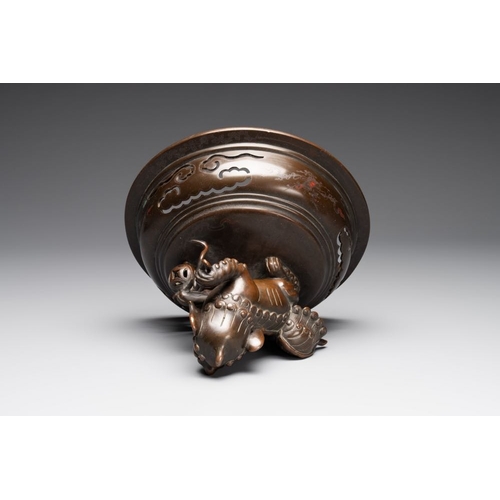 172 - A massive Vietnamese copper- and silver-inlaid 'Buddhist lion' censer and cover on stand, 19th C.L.:... 