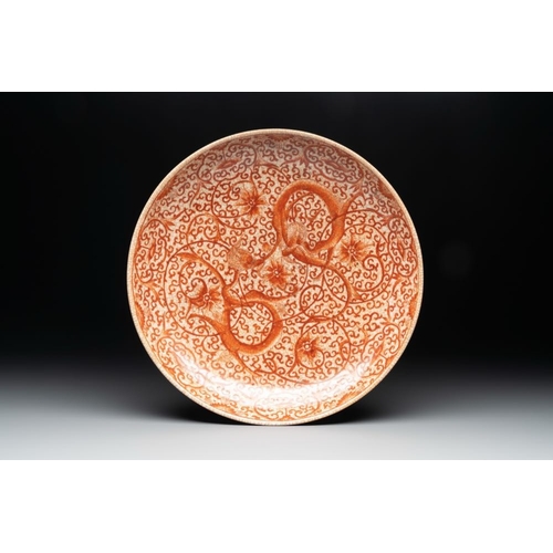 87 - A Chinese iron-red-decorated crackle-glazed 'chilong and lotus scroll' plate, Jiajing mark, 19th C.D... 