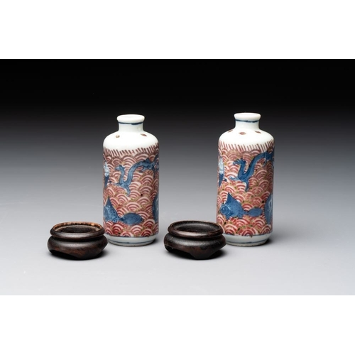 97 - A pair of Chinese blue, white and copper-red 'mythical beasts' and a famille rose 'grasshopper' snuf... 