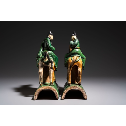 20 - A pair of Chinese sancai-glazed 'Horseriders' roof tiles on wooden stands, MingDim.: 27 x 13 x 38 cm... 