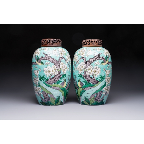 30 - A pair of fine Chinese famille verte turquoise-ground 'Magpie and Prunus' jars with reticulated wood... 