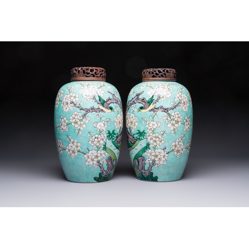 30 - A pair of fine Chinese famille verte turquoise-ground 'Magpie and Prunus' jars with reticulated wood... 