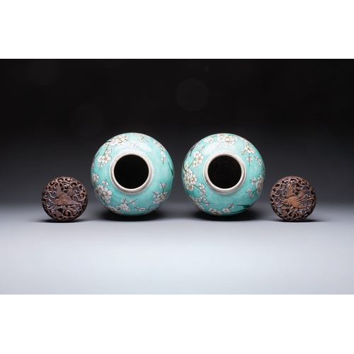 30 - A pair of fine Chinese famille verte turquoise-ground 'Magpie and Prunus' jars with reticulated wood... 