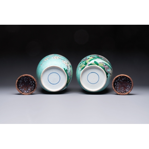 30 - A pair of fine Chinese famille verte turquoise-ground 'Magpie and Prunus' jars with reticulated wood... 