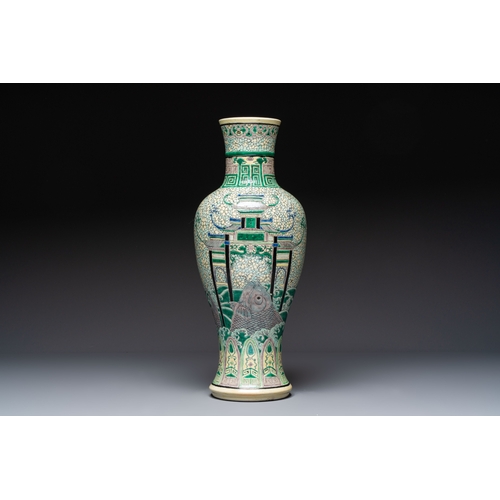 33 - A Chinese verte biscuit 'Dragon Gate Carp' vase on a wooden stand, Xuande mark, 19th C.H.: 63 cm (in... 
