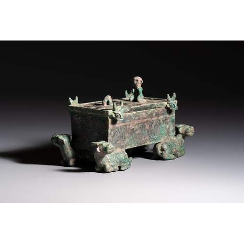 242 - A Chinese archaic bronze cosmetic box standing on four stylised buffalo-form feet, Lian, Eastern Zho... 