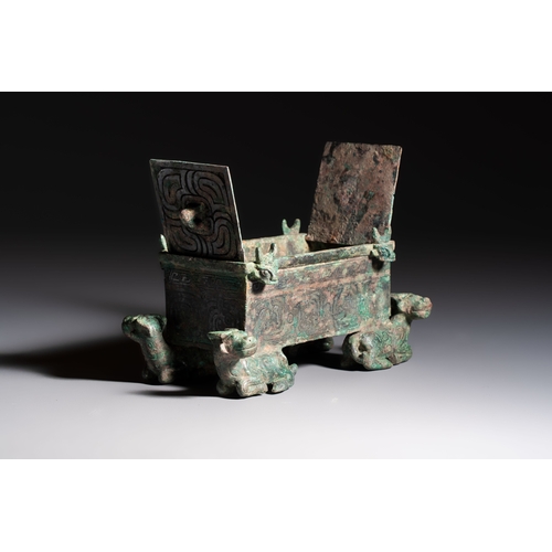 242 - A Chinese archaic bronze cosmetic box standing on four stylised buffalo-form feet, Lian, Eastern Zho... 
