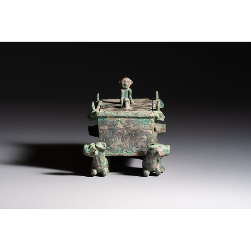 242 - A Chinese archaic bronze cosmetic box standing on four stylised buffalo-form feet, Lian, Eastern Zho... 