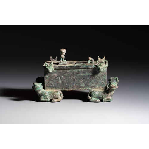 242 - A Chinese archaic bronze cosmetic box standing on four stylised buffalo-form feet, Lian, Eastern Zho... 