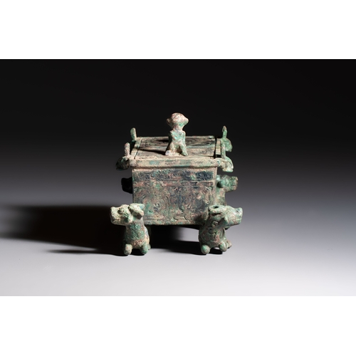242 - A Chinese archaic bronze cosmetic box standing on four stylised buffalo-form feet, Lian, Eastern Zho... 