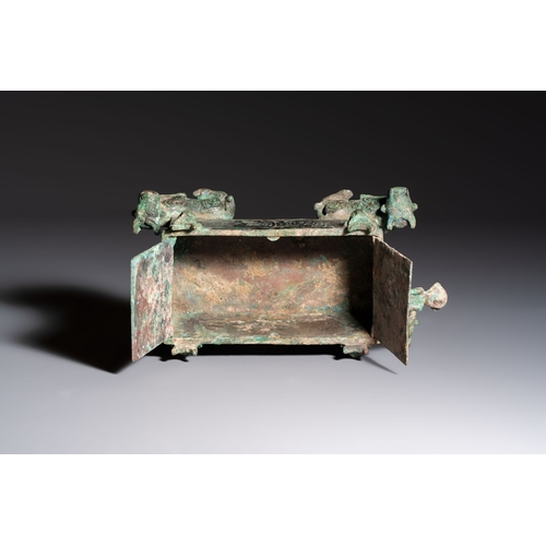 242 - A Chinese archaic bronze cosmetic box standing on four stylised buffalo-form feet, Lian, Eastern Zho... 