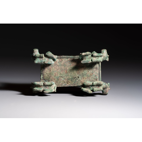 242 - A Chinese archaic bronze cosmetic box standing on four stylised buffalo-form feet, Lian, Eastern Zho... 