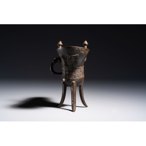 253 - A Chinese archaistic bronze ritual wine vessel, Jue, Qianlong mark, dated 1738L.: 17,5 cm - H.: 16,5... 