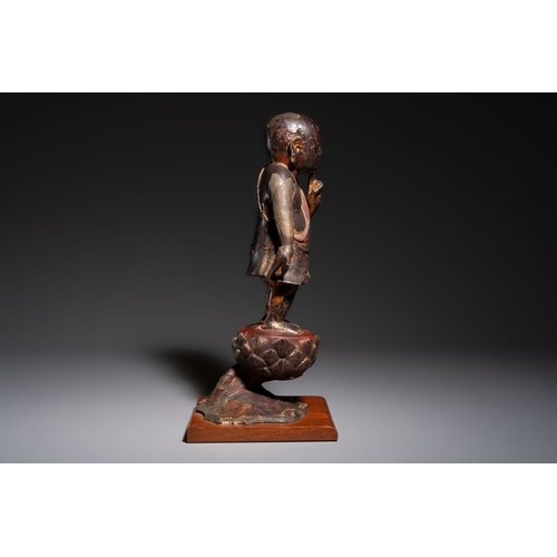 257 - A rare Chinese gilt-lacquered bronze Buddha standing on a lotus throne, MingH.: 46 cm (incl. stand)H... 
