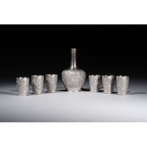 294 - A Chinese Canton or Vietnamese silver bottle vase with landscape design and six cups, 19th C.H.: 12 ... 