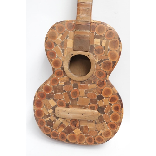 229 - A Wooden Guitar by famous sculptor and artist Maxie Lane. The item remains in great condition, and i... 