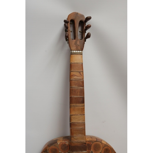 229 - A Wooden Guitar by famous sculptor and artist Maxie Lane. The item remains in great condition, and i... 