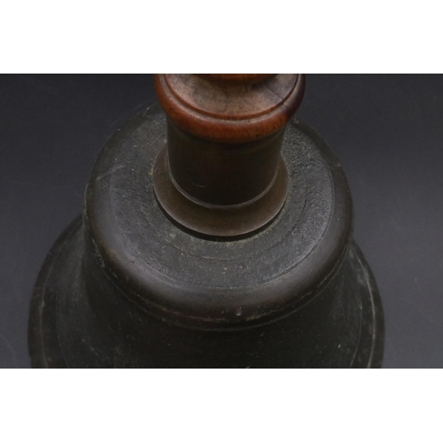 343 - A vintage handheld bell with with wooden handle. (11 inches)