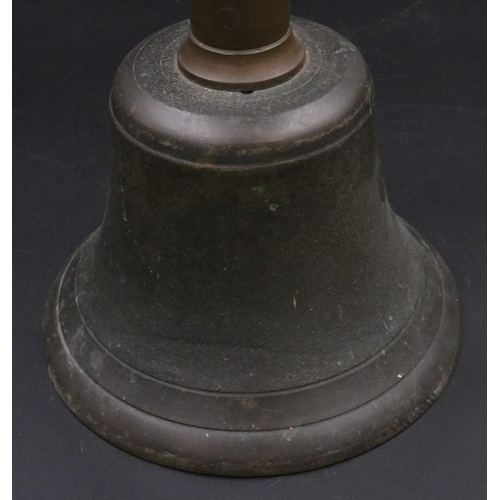 343 - A vintage handheld bell with with wooden handle. (11 inches)