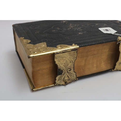 36 - An 1890 Leather and Brass Bible with an abridgement of the commentaries of Scott & Henry. All conden... 