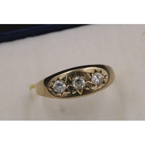 95 - 9CT Gold Ring Set with 3 Clear Stones which do not test as diamond. Over all weight 3.2grams