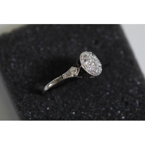 111 - A diamond cluster ring, with diamond shoulders, set in Platinum, ring size Q