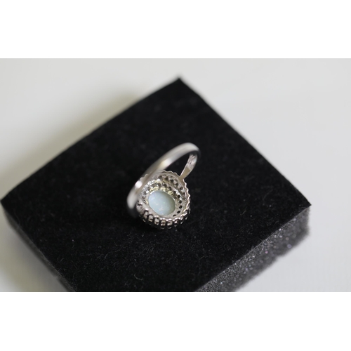 113 - An Oval white opal an diamond cluster ring, set in 9ct white gold, ring size O