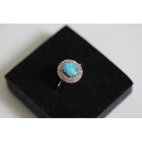 114 - A Oval Opal & diamond cluster ring, set in 9ct yellow gold Ring size P (this item has no hallmarks p... 