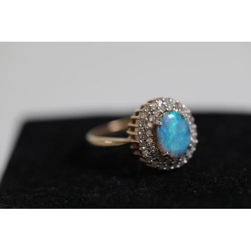 114 - A Oval Opal & diamond cluster ring, set in 9ct yellow gold Ring size P (this item has no hallmarks p... 