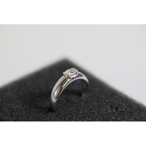 116 - A 0.5 diamond solitaire ring, set in rub over setting, in 18ct white gold, ring size N-O