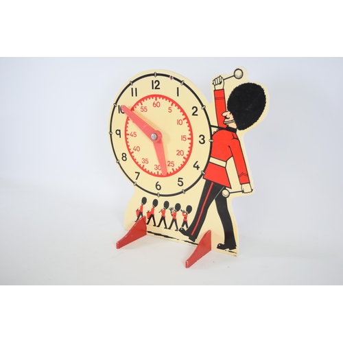 12 - A nice and old school teaching the time clock in good condition Size is 32cm in height and the width... 