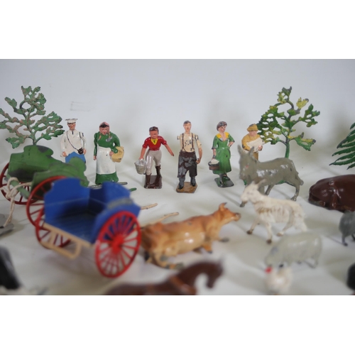 131 - Over 60 items of vintage Britain's lead farm animals, people and scenery