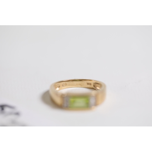 187 - Emerald Cut peridot with diamond shoulders in 9ct yellow gold between O and P