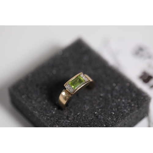 187 - Emerald Cut peridot with diamond shoulders in 9ct yellow gold between O and P